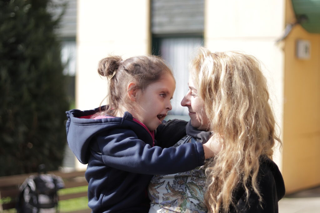 Ein ukrainisches Mädchen umarmt ihre Mutter, die in Deutschland ein neues Zuhause gefunden hat.
